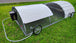 Portable chicken coop with wheels on a grassy area