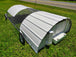Portable chicken coop on wheels in a grassy area