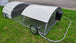 Portable chicken coop with wheels on a grassy area
